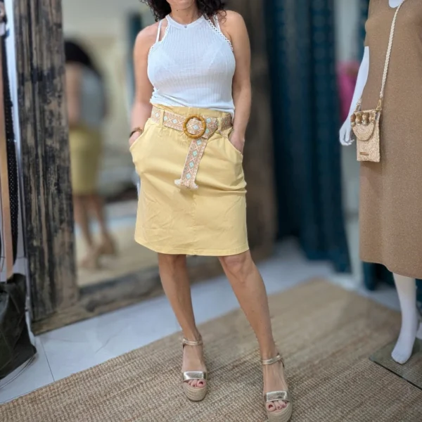 Jupe courte de couleur jaune, porté par un mannequin